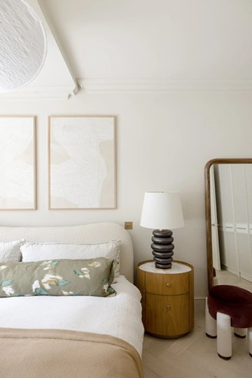 Bedroom detail with artwork, timber bedside table and lamp