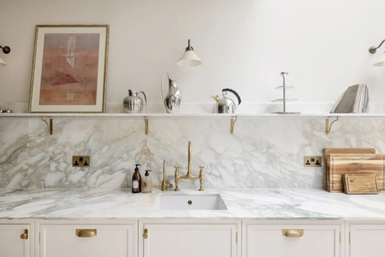 Calacatta marble splashback with brass tap and shelf styling