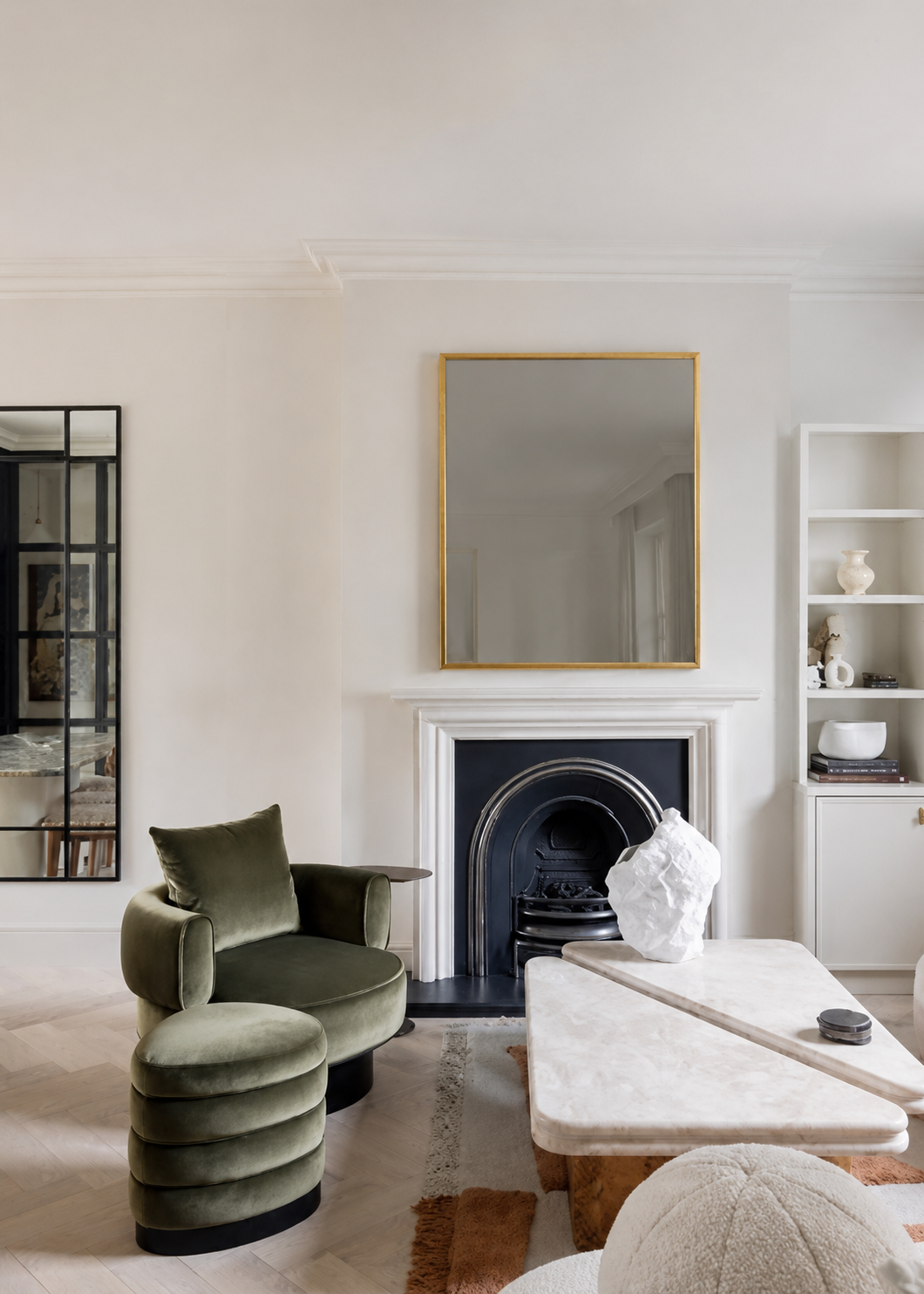 Period fireplace with gilt mirror and green velvet armchair