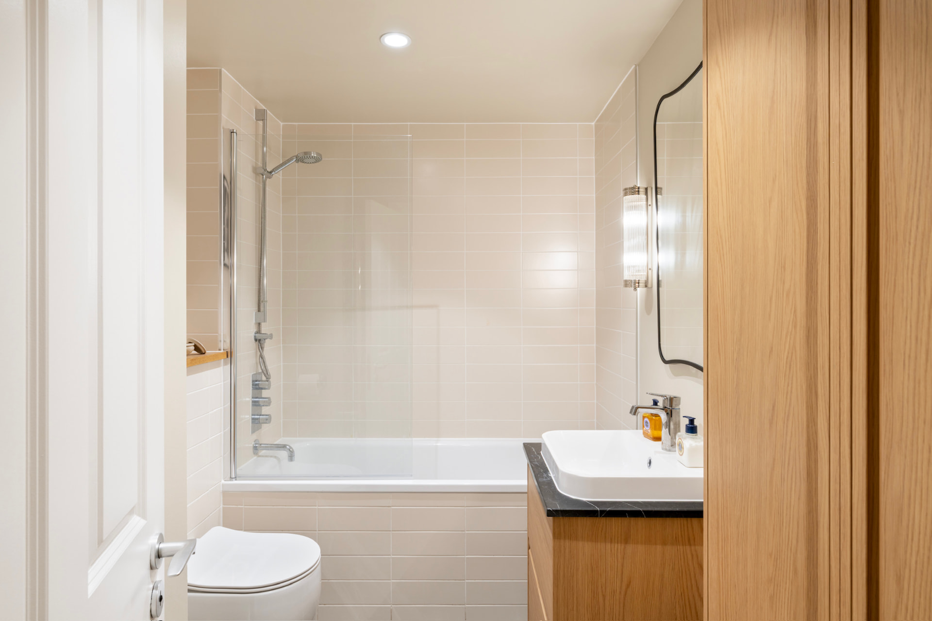 Family bathroom with bath, oak vanity and marble top