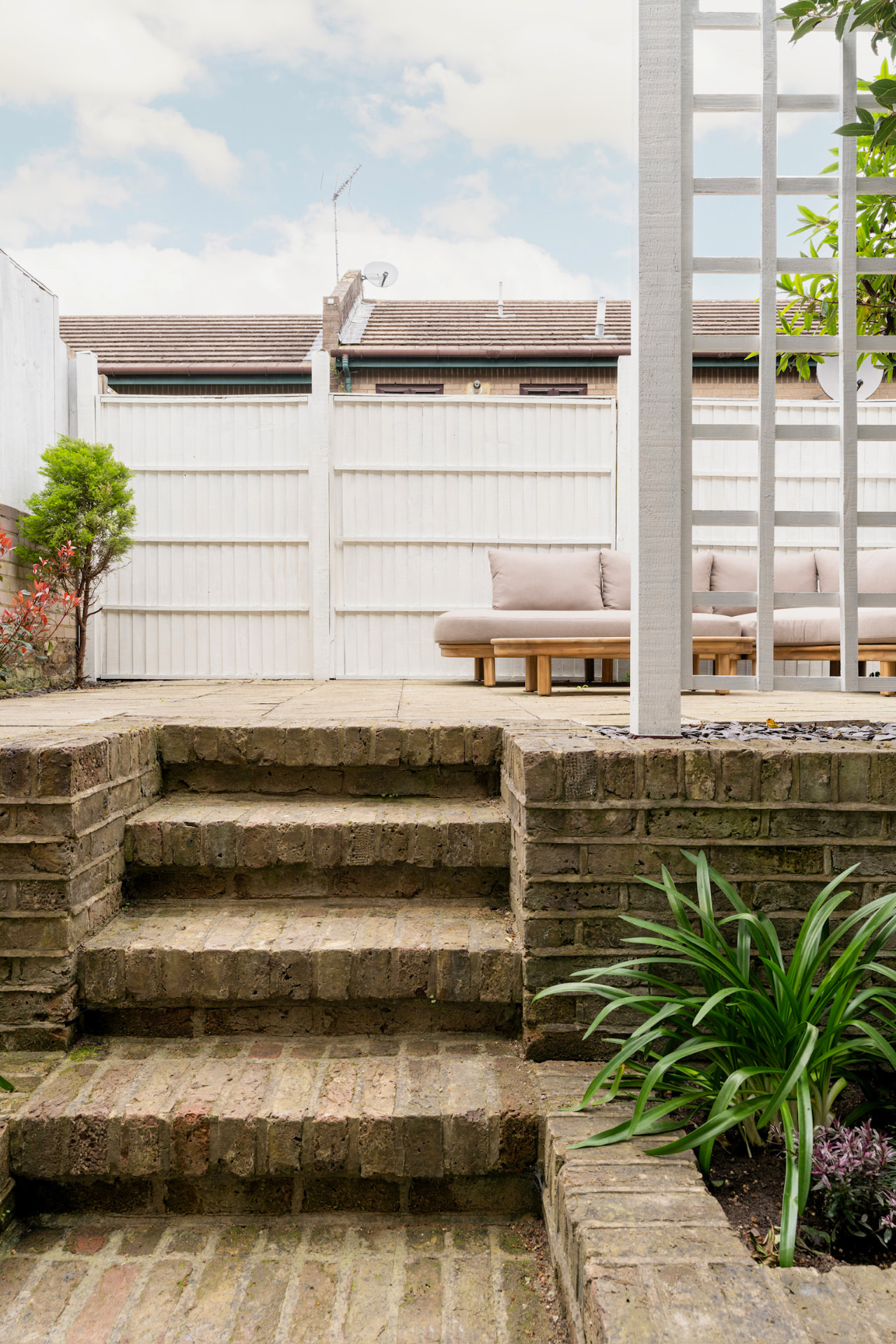 Brick steps leading up to the split-level garden terrace