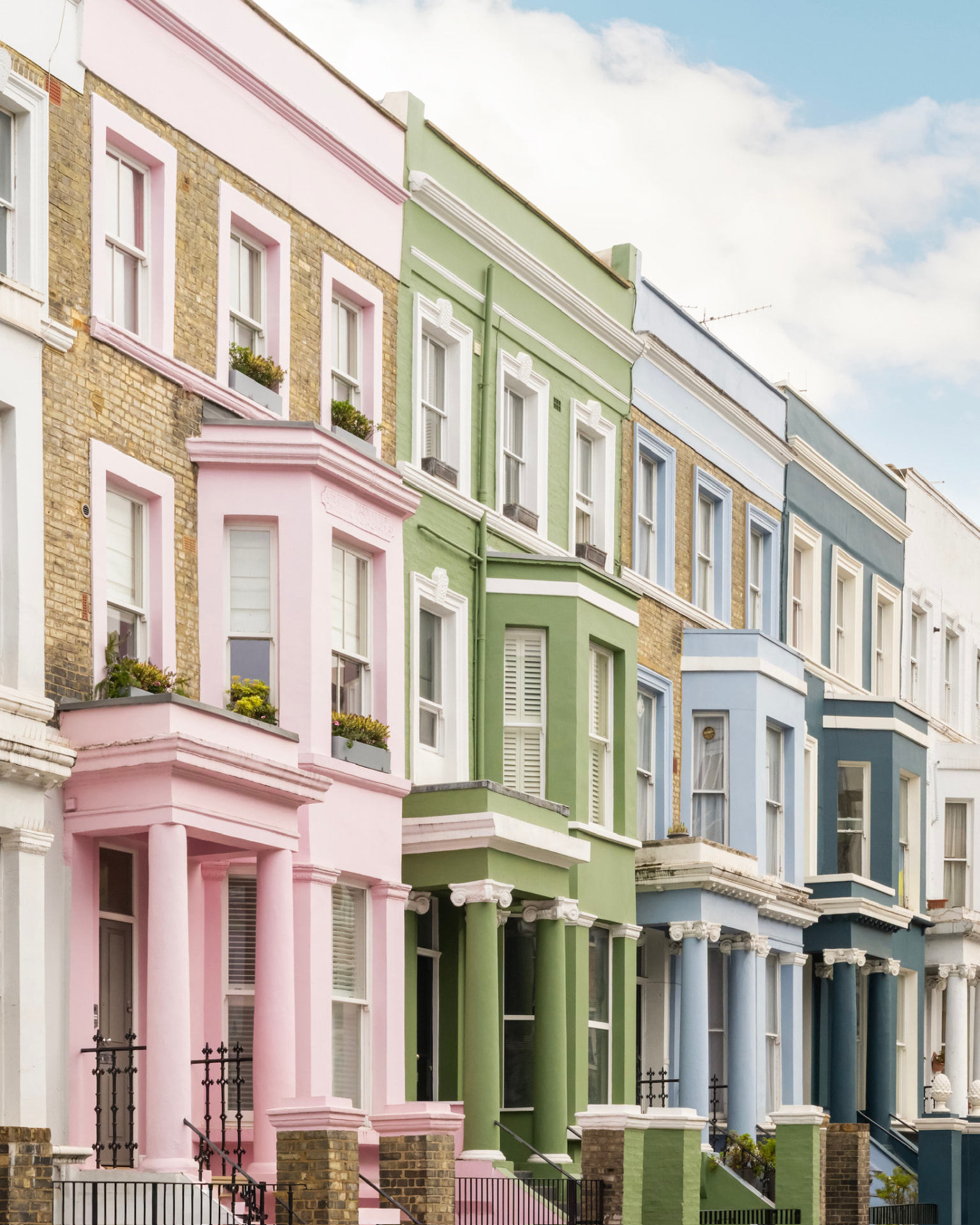 Row of pastel-painted Notting Hill townhouses