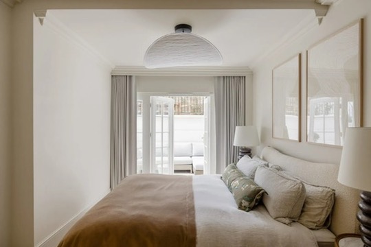 Principal bedroom with French doors opening to the patio