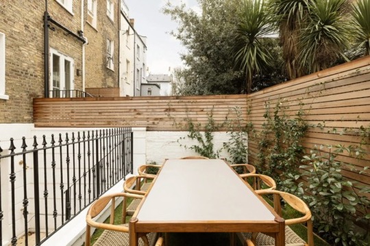 Private terrace with outdoor dining table and cedar screening