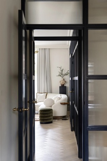 View through reeded glass doors into the sitting room