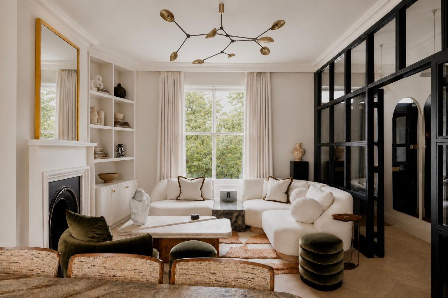Elegant reception room with fireplace, curved sofas and Crittall-style glazing